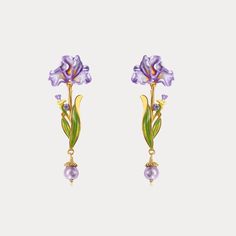 Indulge in elegance and grace with our Iris Flower Drop Earrings. The magnificent iris flower, with its exquisite enamel finish, adds a touch of charm and personality to any outfit. In shades of blue or purple, every flower resembles the fanned tail of a bird or the fluttering wings of a dancing butterfly. With slender, graceful leaves adorned with blue and purple gems, its romantic and elegant charm leaps to life. Adorned with shimmering gemstones and 18K gold, these unique earrings will transp Iris Jewelry, Pearl Purple, Virtual Wardrobe, Flower Drop Earrings, Purple Gems, Iris Flower, Purple Iris, Purple Earrings, Iris Flowers