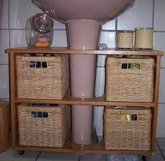 a shelf with baskets on it and a sink in the corner next to some containers