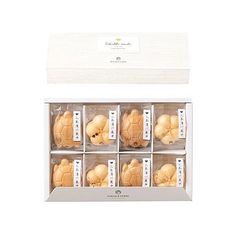 twelve small teddy bears in a white box