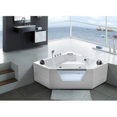 a large white bath tub sitting on top of a bathroom floor next to a window