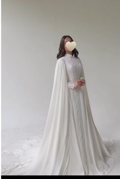 a mannequin dressed in a white wedding gown with a heart on it's chest