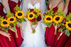 the bride and her bridesmaids are holding sunflowers in their bouquets