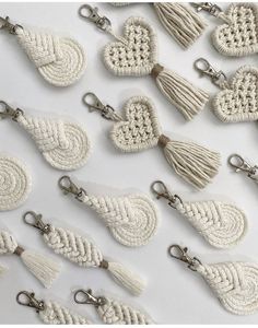 crocheted key chains with tassels and hearts on them are arranged in rows