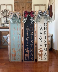 three wooden signs decorated with christmas decorations