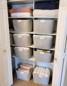 an organized closet with baskets and blankets