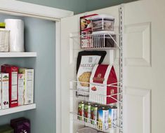 a pantry door is open to show the food in its bins and on the shelf