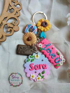 a keychain that says happy soire with sunflowers and other items