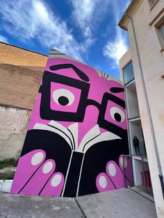 a large pink and black mural on the side of a building