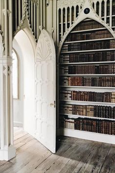 an old book shelf with many books in it and a doorway leading to another room