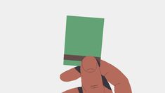 a hand holding a green piece of paper