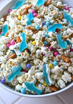 a bowl filled with white and blue candy popcorn