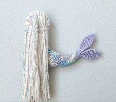 a knitted mermaid tail hanging on the wall