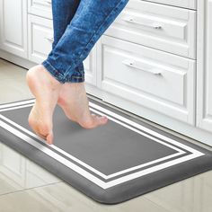 a person stepping on a mat in a kitchen