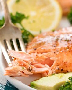 a close up of a plate of food with salmon and broccoli