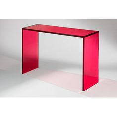 a red glass table sitting on top of a white floor