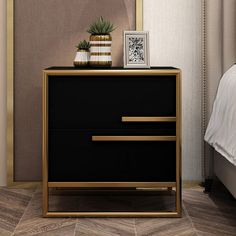 a black and gold chest of drawers next to a white bed with a plant on top