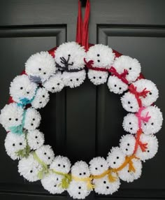 a crocheted wreath is hanging on the front door