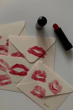 four envelopes with red lipstick prints on them