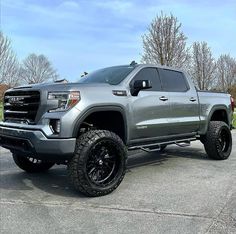 a silver truck parked in a parking lot