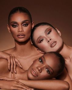 three nude women posing for the camera with their arms around each other and one woman's chest