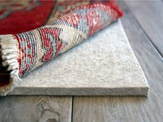 a rug is laying on the floor with it's end rolled up in front of it