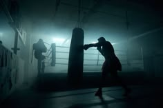 a man is boxing in the dark by himself