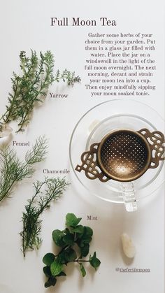 a cup of tea sitting on top of a table next to some herbs and leaves