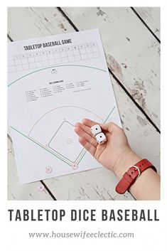 a hand holding two dices in front of a table top baseball game paper with the words tabletop dice baseball written on it