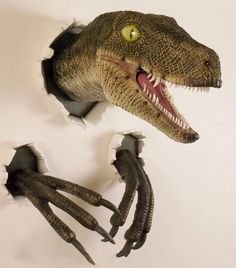 a dinosaur's head is shown through the holes in a wall with its mouth open