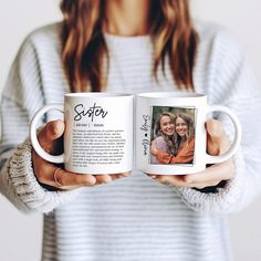 a woman holding two coffee mugs with the words sister and brother printed on them