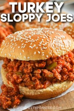 two sloppy joes are sitting on top of a wooden cutting board with text overlay