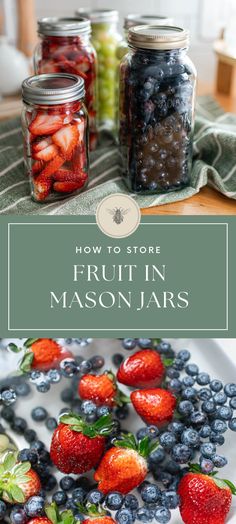 jars filled with fruit sitting on top of a table next to blueberries and strawberries