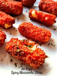 some food is on a white plate and ready to be eaten with the words air fryer spicy mozzarella sticks