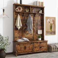 a large wooden cabinet sitting next to a plant in a living room filled with furniture