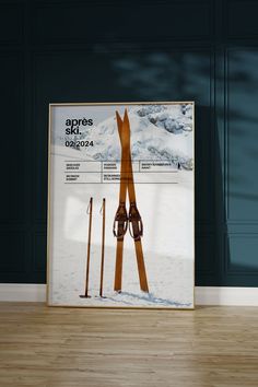 a poster with skis and poles on the floor in front of a blue wall