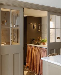 an open door leading to a kitchen and dining room