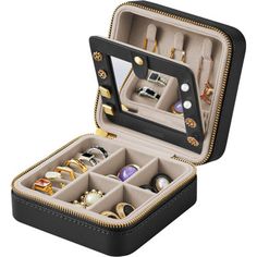 an open jewelry box with many different items in it's compartments on a white background