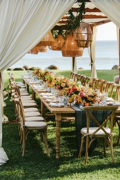 a long table set up for an outdoor dinner