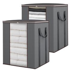 two storage bins with handles, one is grey and the other has white sheets