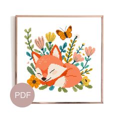 a cross stitch fox with flowers and butterflies on it's face is shown in the frame