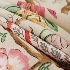 four fabrics with different designs on them, one is white and the other has pink flowers