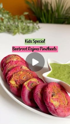 a white plate topped with beetroot and green sauce next to other food items