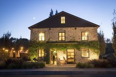 a stone house with lights on at night