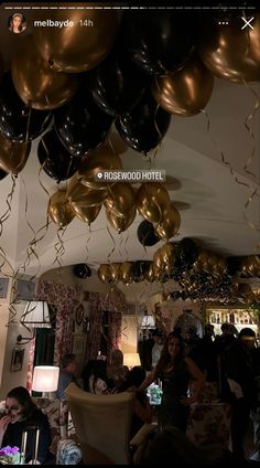 a room filled with lots of balloons floating from the ceiling