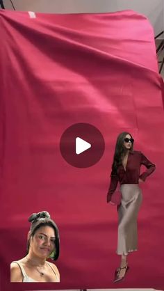 a woman standing in front of a giant red sheet with an image of herself on it