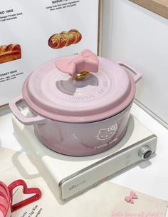 a pink casserole dish sitting on top of a table