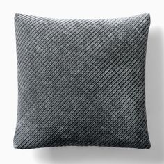 a black and white pillow sitting on top of a wall