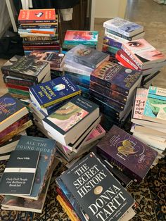 a pile of books sitting on top of a rug