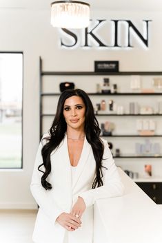 a woman standing in front of a skin store