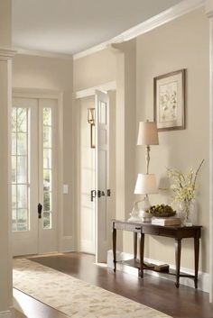 Transform your entryway with the timeless charm of Benjamin Moore's Pale Oak - the perfect 2024 wall color. Discover how to create a welcoming foyer that Pale Oak Walls Benjamin Moore, Eggshell Wall Color, Modern Room Paint Wall Colors, Wainscoting Color Ideas Living Room, Cream Walls With White Trim Living Room, Ivory Wall Paint Living Room, Passive Sherwin Williams Color Scheme, Bm Pale Oak Coordinating Colors, Entry Way Colors Paint Foyers